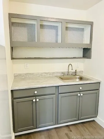 a view of kitchen and utility room with wooden floor