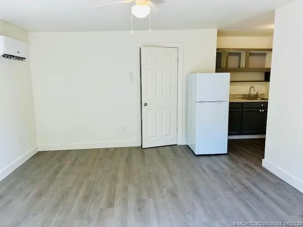 a kitchen with a refrigerator and a stove
