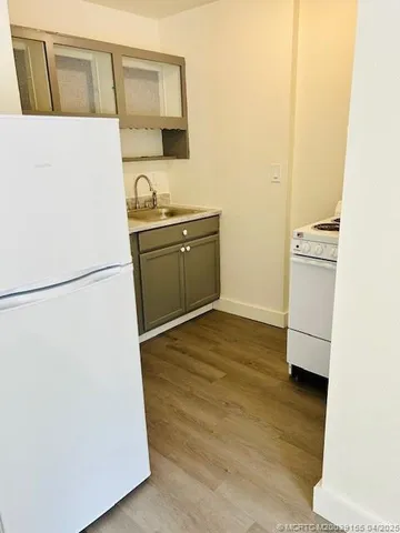 a bathroom with a shower and a sink