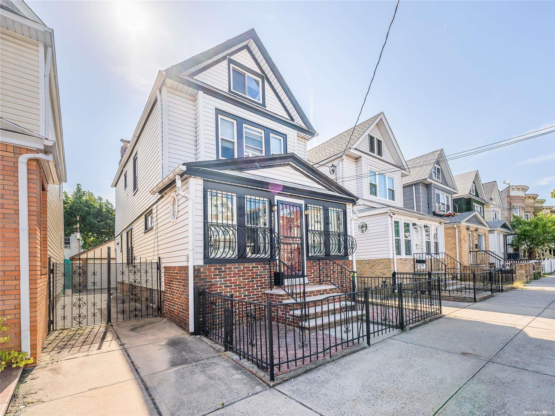88-32 74th Place Queens, NY 11421 - Photo 1 of 1 a front view of a house with iron fence