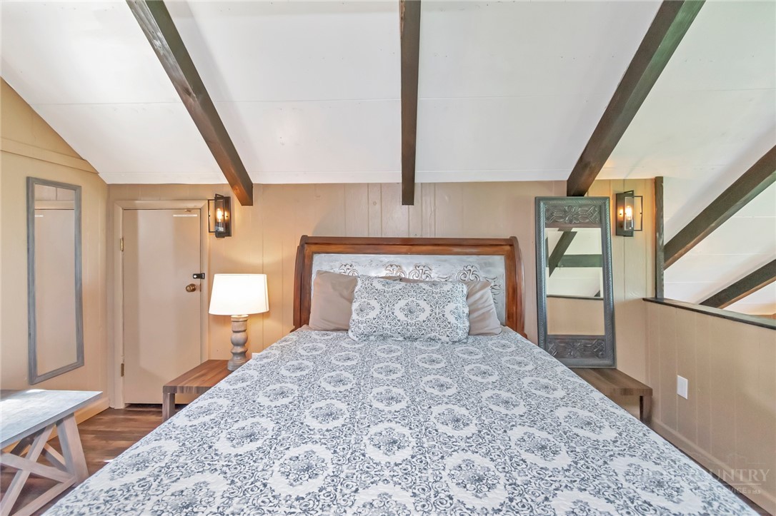 115 North Pinnacle Ridge Road, Unit 46 Beech Mountain, NC 28604 - Photo 34 of 42 a bedroom with a large bed and a window