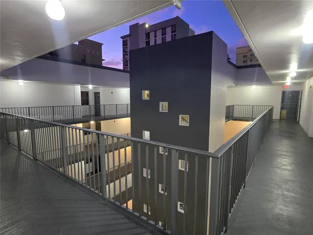 a view of staircase with railing and white walls