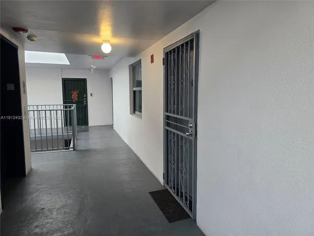 a front view of a multi story building with yard