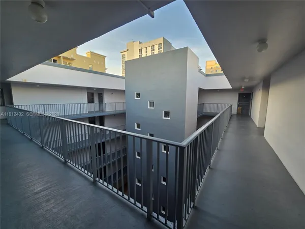 a view of staircase with railing and white walls
