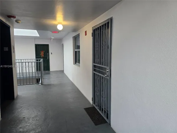 a view of a hallway with entryway door
