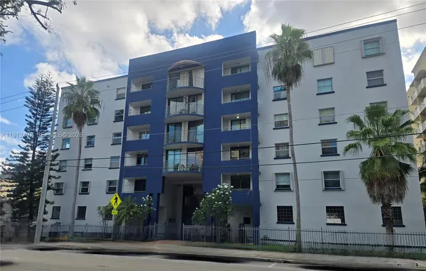 a front view of a multi story building with yard