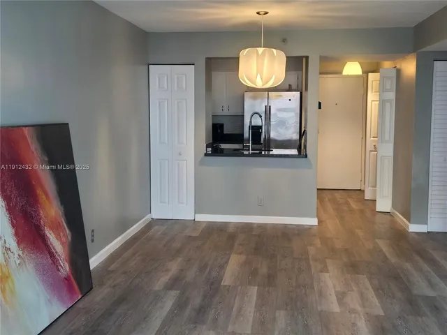 a kitchen with a refrigerator a stove and a sink