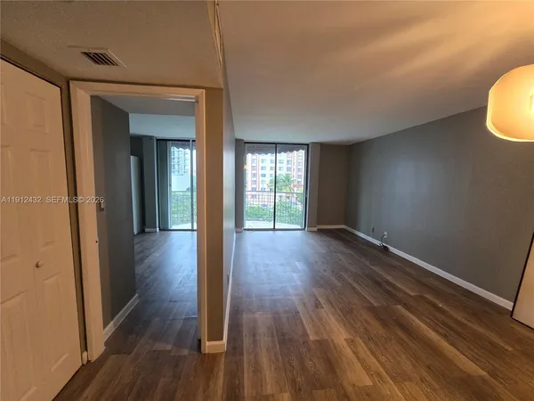 a view of hallway with wooden floor
