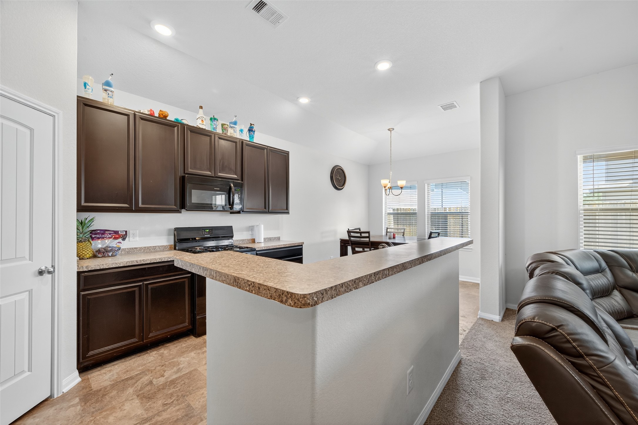 7615 Nevaeh Crest Path Houston, TX 77016 - Photo 13 of 37 a kitchen with stainless steel appliances granite countertop a sink stove and refrigerator