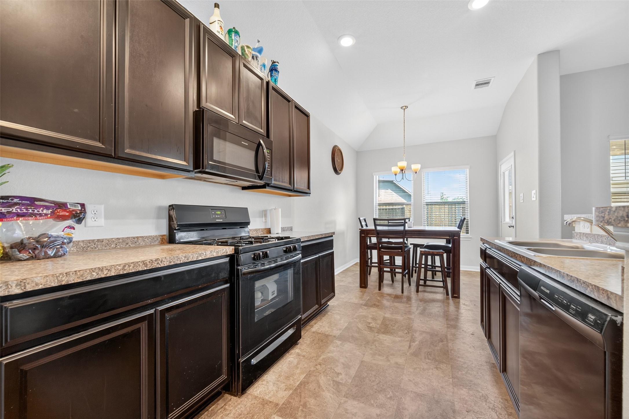 7615 Nevaeh Crest Path Houston, TX 77016 - Photo 15 of 37 a kitchen with stainless steel appliances granite countertop a stove a sink and a microwave