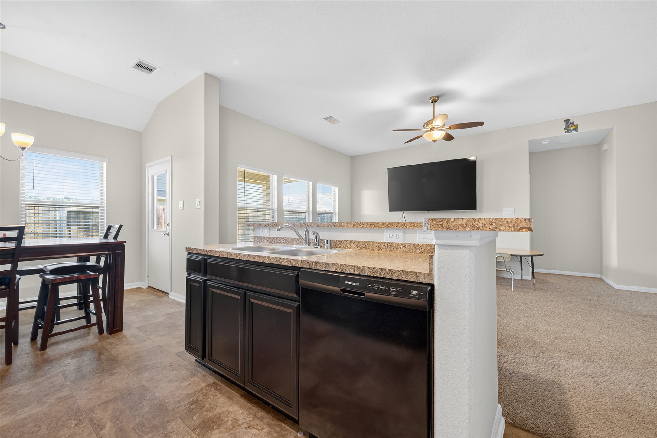 7615 Nevaeh Crest Path Houston, TX 77016 - Photo 17 of 37 a kitchen with a sink and a stove top oven with wooden floor