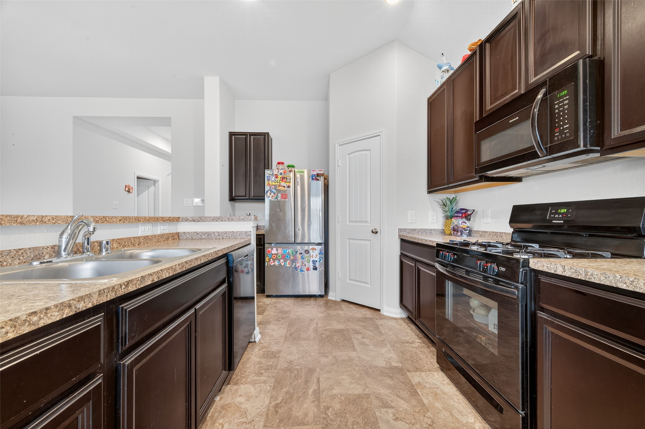 7615 Nevaeh Crest Path Houston, TX 77016 - Photo 19 of 37 a kitchen with stainless steel appliances granite countertop a stove microwave and sink