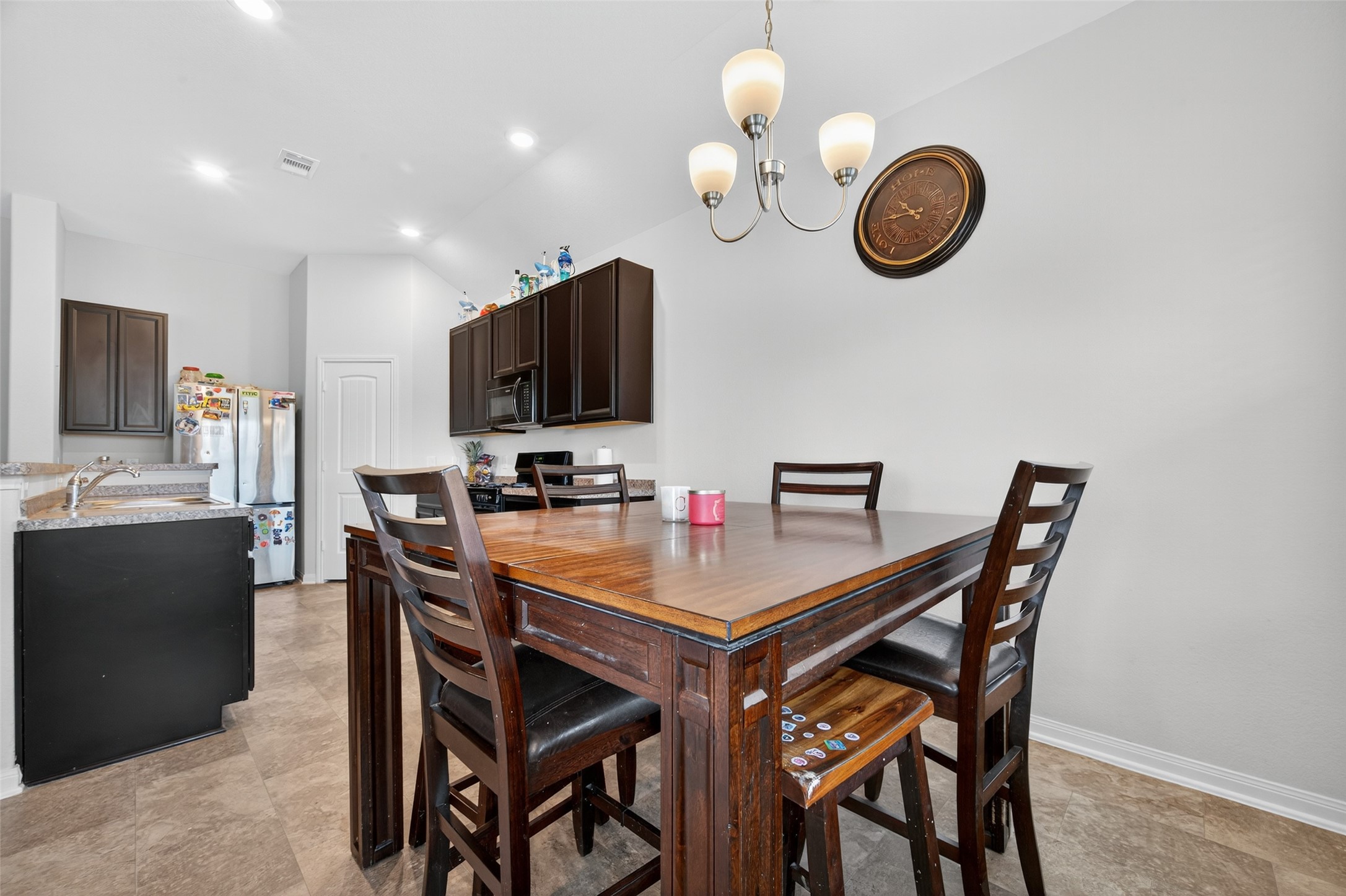7615 Nevaeh Crest Path Houston, TX 77016 - Photo 23 of 37 a view of a dining room and a kitchen with a table chairs