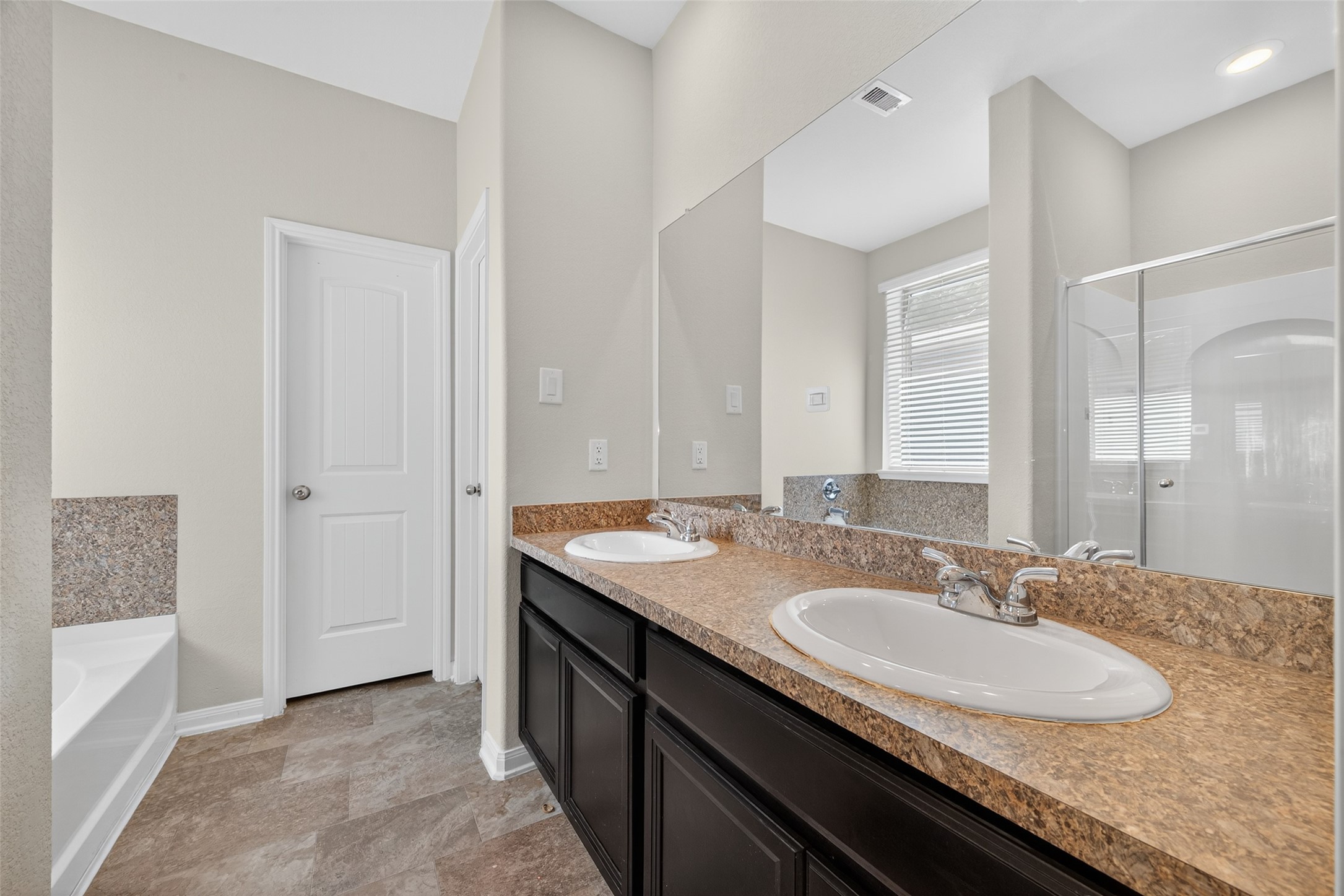 7615 Nevaeh Crest Path Houston, TX 77016 - Photo 28 of 37 a bathroom with a granite countertop sink and a mirror