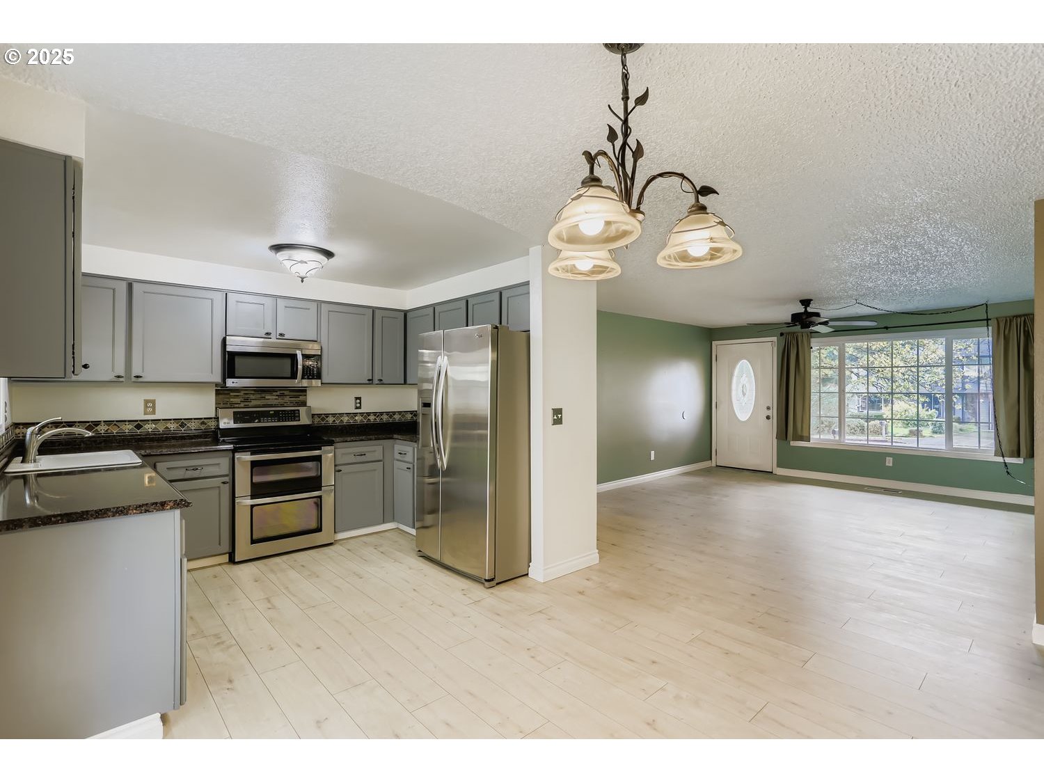 120 Northwest Giese Avenue Gresham, OR 97030 - Photo 6 of 17 a view of kitchen with sink microwave and refrigerator