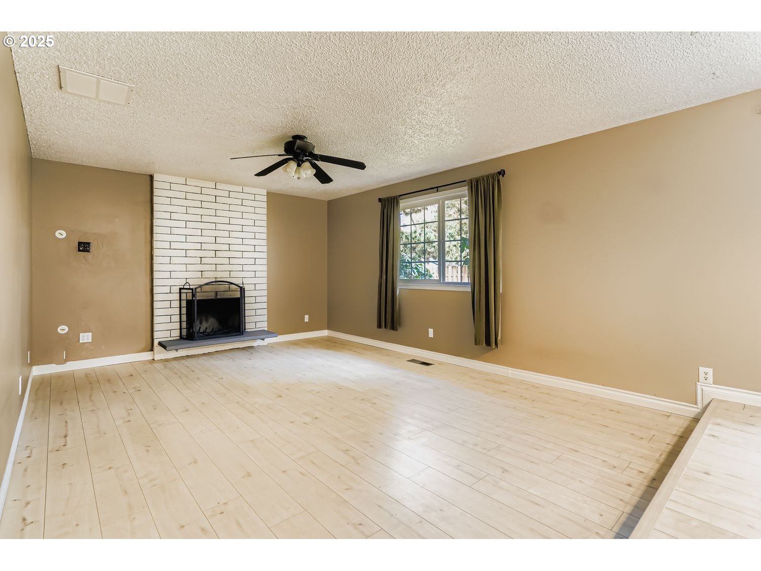 120 Northwest Giese Avenue Gresham, OR 97030 - Photo 7 of 17 a view of an empty room with a fireplace and a window