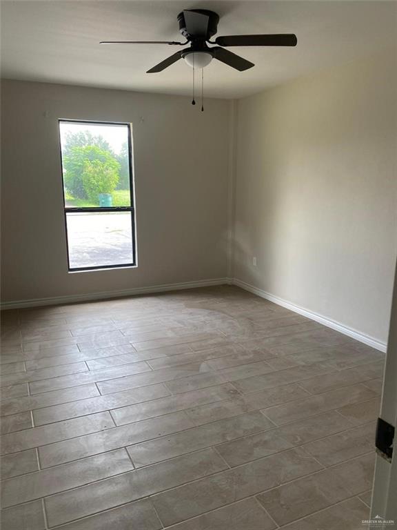 2114 Monterrey Hidalgo, TX 78557 - Photo 6 of 17 an empty room with a window and a fan