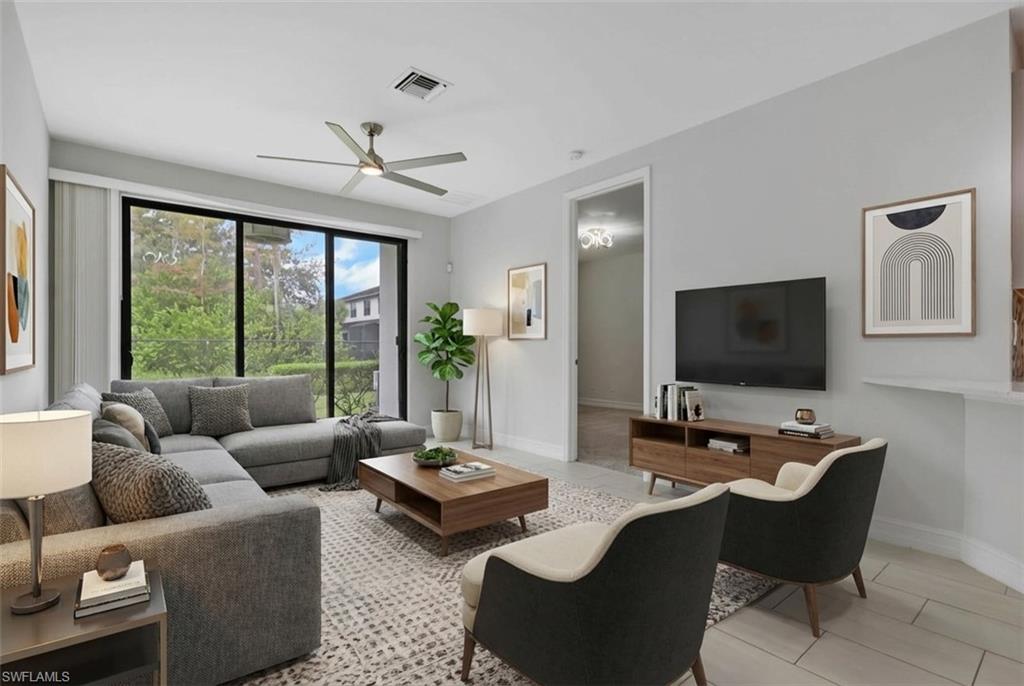 7501 Carnegie Way Naples, FL 34119 - Photo 11 of 37 Living area with light tile patterned floors and a ceiling fan