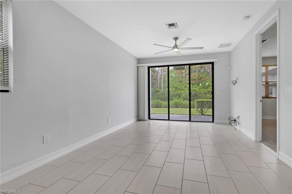 7501 Carnegie Way Naples, FL 34119 - Photo 14 of 37 Unfurnished room featuring baseboards and ceiling fan