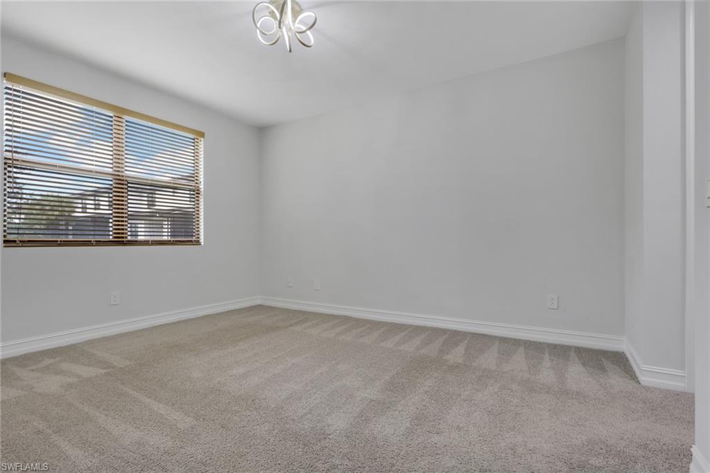 7501 Carnegie Way Naples, FL 34119 - Photo 16 of 37 Spare room featuring light carpet and baseboards