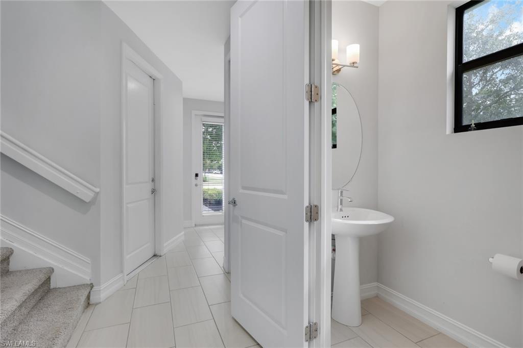 7501 Carnegie Way Naples, FL 34119 - Photo 22 of 37 Half bathroom with light tile patterned flooring