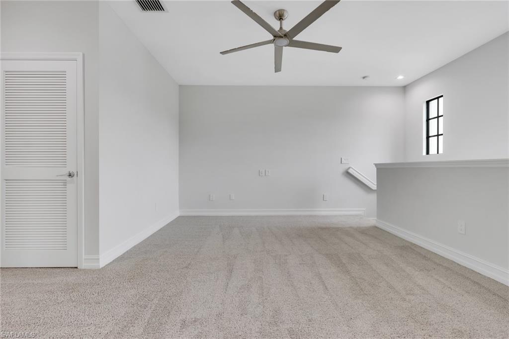 7501 Carnegie Way Naples, FL 34119 - Photo 26 of 37 Empty room with light colored carpet, ceiling fan, and recessed lighting