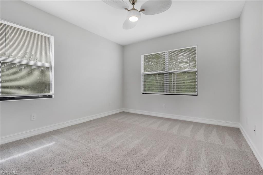 7501 Carnegie Way Naples, FL 34119 - Photo 32 of 37 Unfurnished room with light carpet and a ceiling fan
