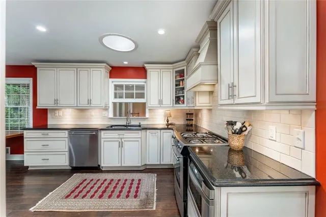 a kitchen with a sink stove and cabinets