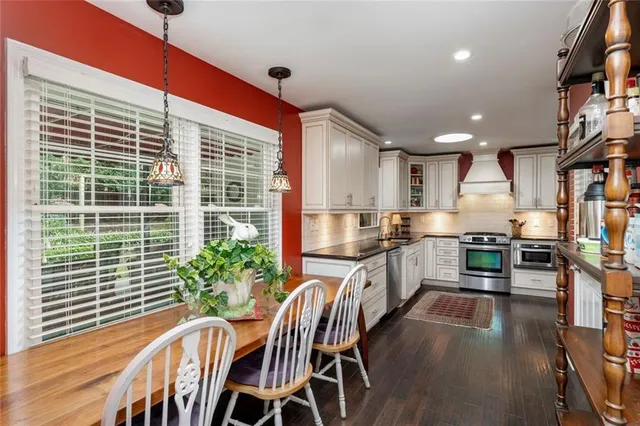 a kitchen with furniture and wooden floor