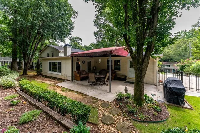 a backyard of a house with yard barbeque oven and outdoor seating