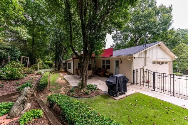 a front view of house with a garden and patio