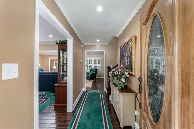 a view of a hallway and a livingroom with furniture