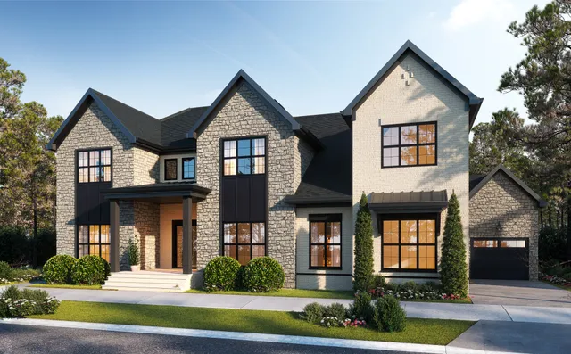 a front view of a house with a yard and plants