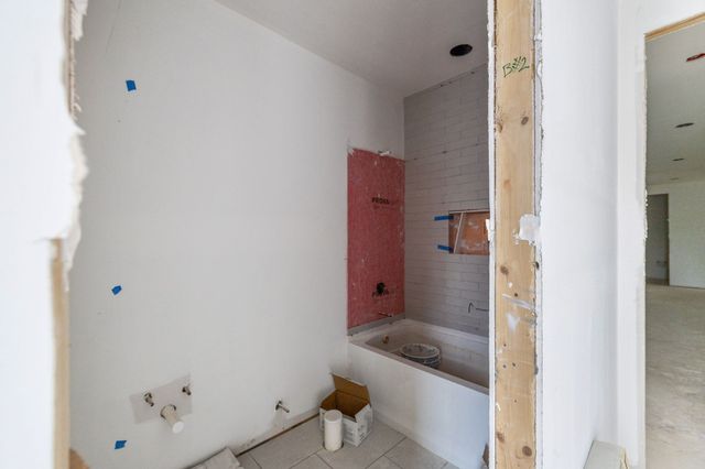 a bathroom with a bathtub and shower