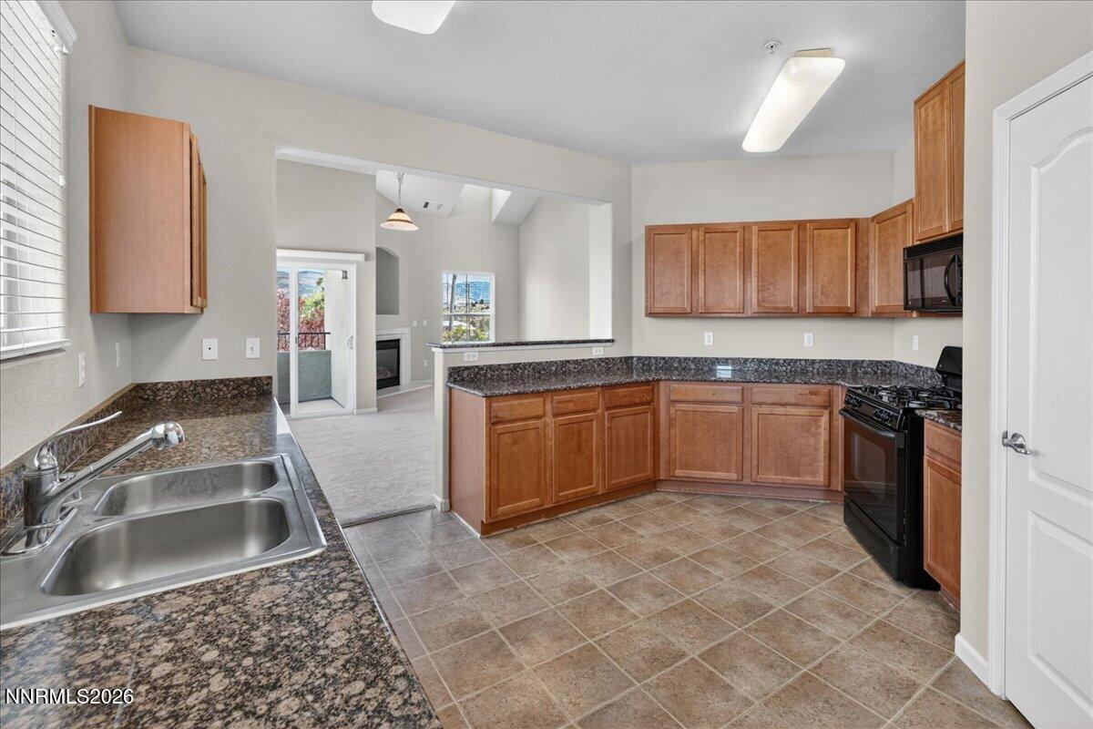 17000 Wedge Parkway, Unit 1525 Reno, NV 89511 - Photo 18 of 42 a kitchen with a sink stove top oven and granite counter tops