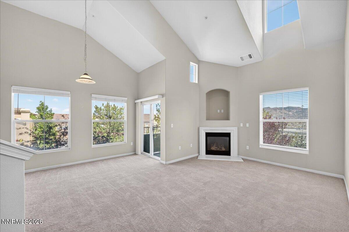 17000 Wedge Parkway, Unit 1525 Reno, NV 89511 - Photo 7 of 42 an empty room with furniture and a fireplace