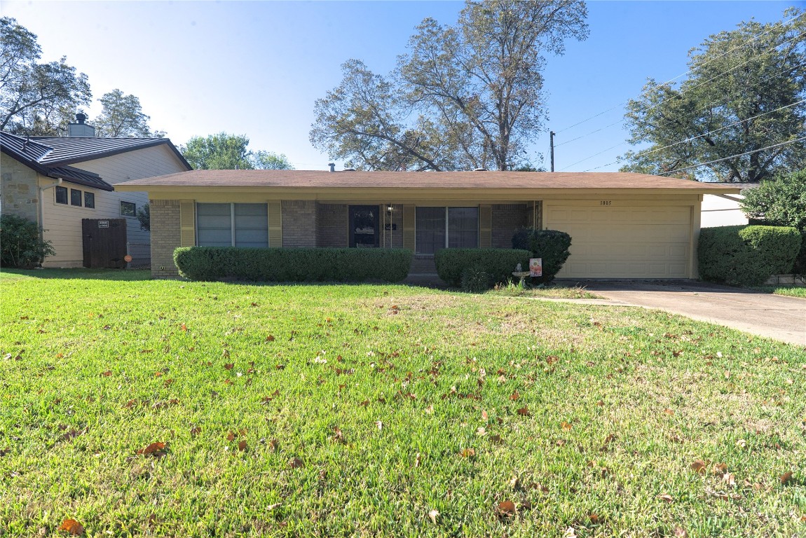 a view of a house with a yard and tree
