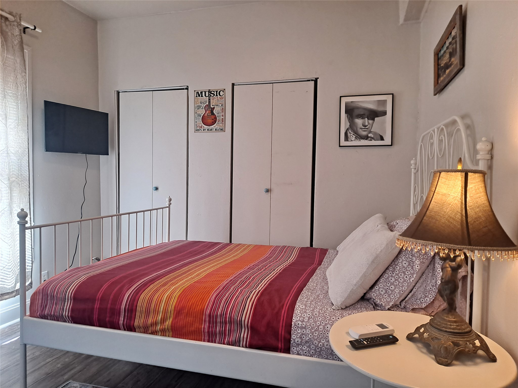 1906 San Gabriel Street, Unit 9 Austin, TX 78705 - Photo 3 of 9 Bedroom with multiple closets and wood finished floors