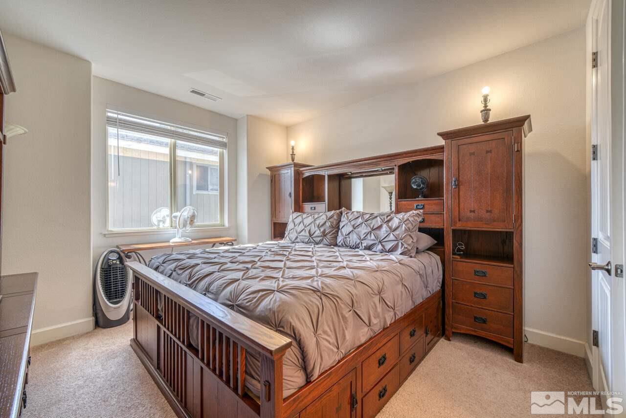 3677 Warren Way, Unit A Reno, NV 89509 - Photo 11 of 22 a bedroom with a bed and a dresser