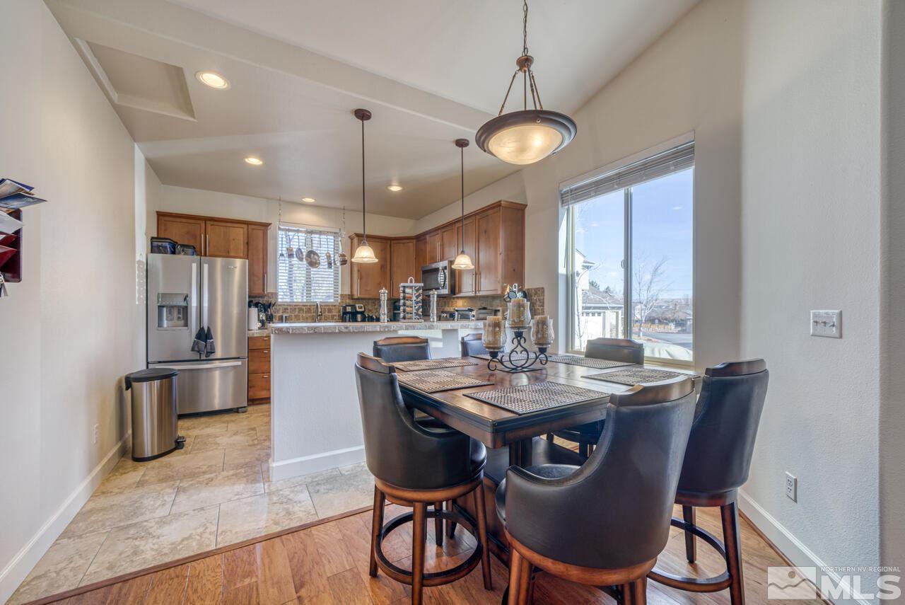 3677 Warren Way, Unit A Reno, NV 89509 - Photo 16 of 22 a view of a dining room with furniture window and wooden floor