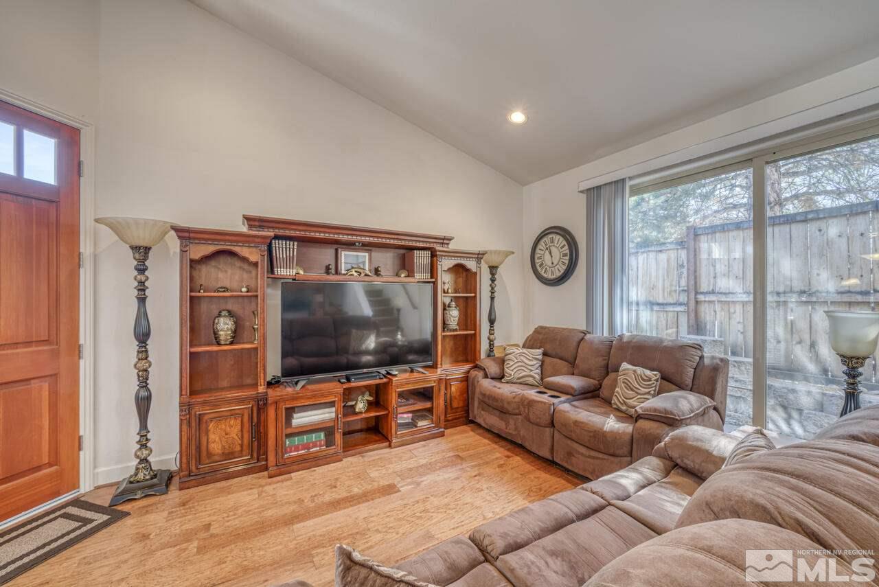 3677 Warren Way, Unit A Reno, NV 89509 - Photo 20 of 22 a living room with furniture a flat screen tv and a large window