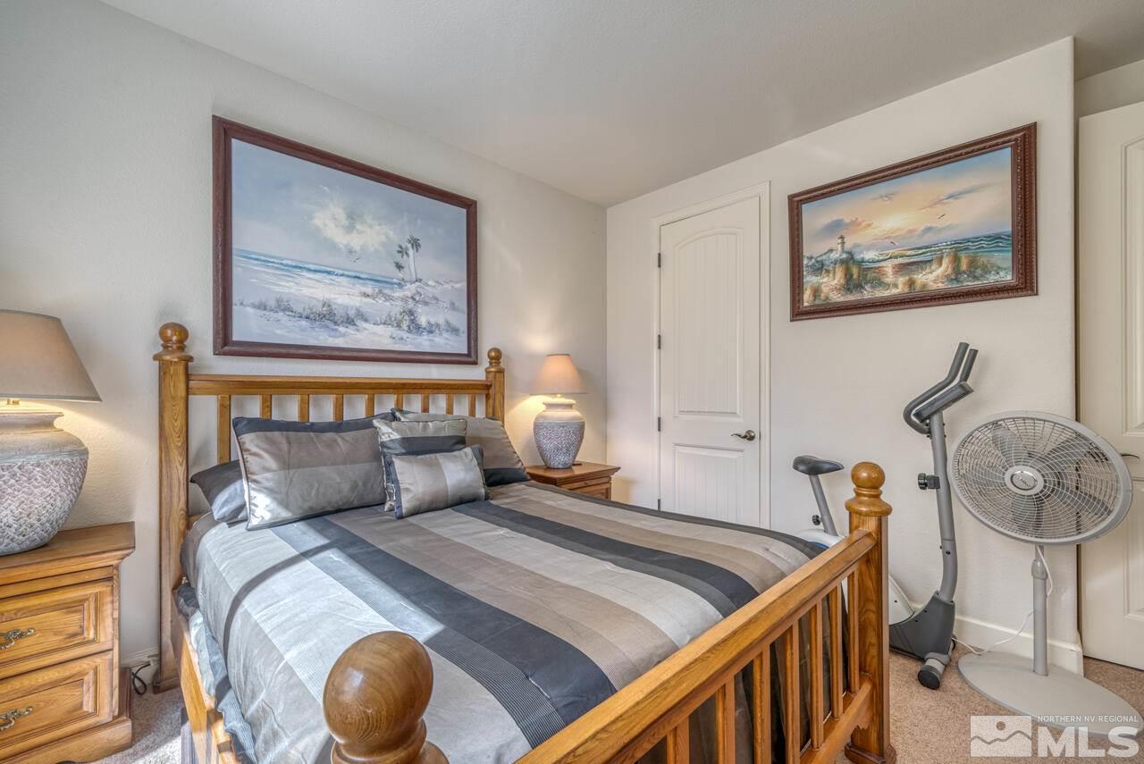 3677 Warren Way, Unit A Reno, NV 89509 - Photo 7 of 22 a bedroom with a bed and the painting on the wall