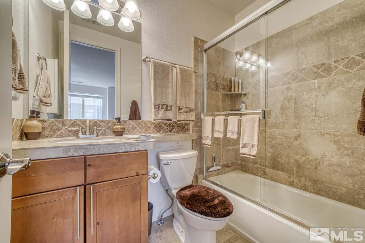 3677 Warren Way, Unit A Reno, NV 89509 - Photo 9 of 22 a bathroom with a sink toilet and shower