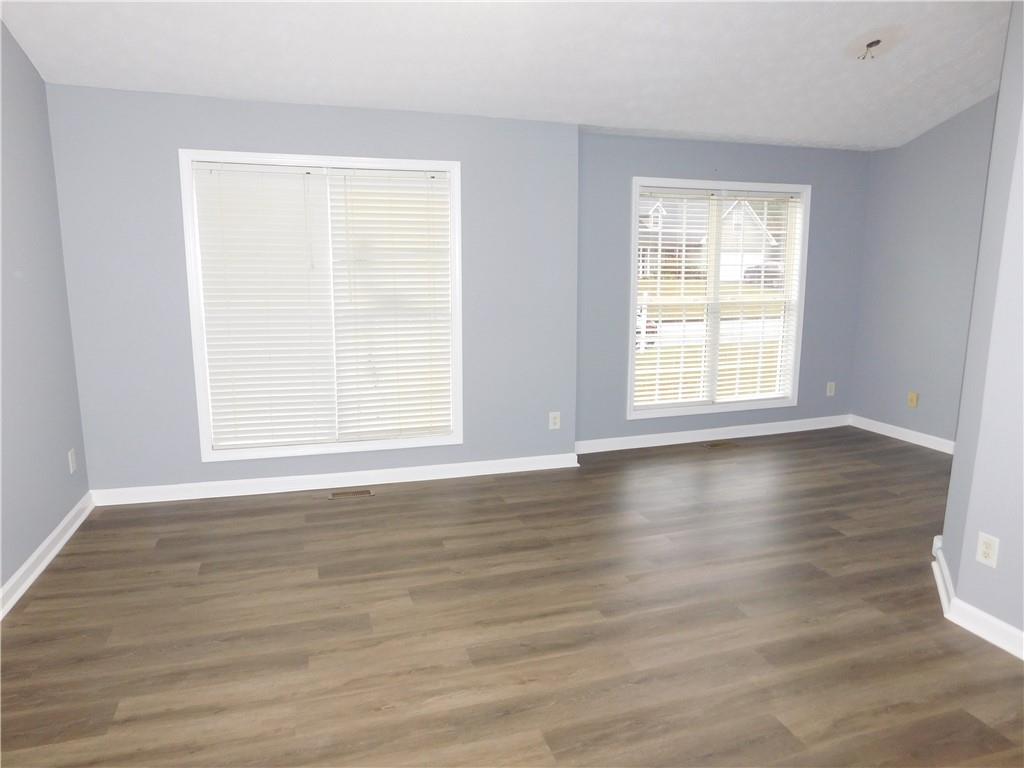 2614 Carolina Court Bethlehem, GA 30620 - Photo 13 of 42 a view of an empty room with wooden floor and a window