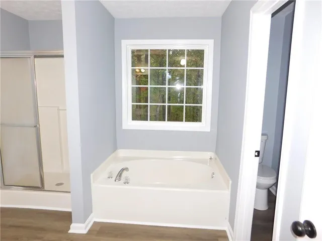 a white bath tub sitting next to a window