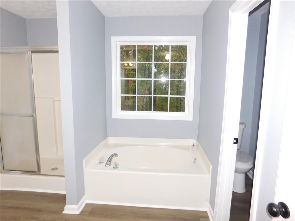 2614 Carolina Court Bethlehem, GA 30620 - Photo 14 of 42 a white bath tub sitting next to a window