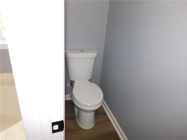 a white toilet sitting next to a white sink