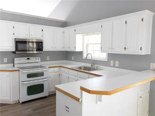a kitchen with appliances a sink and a stove