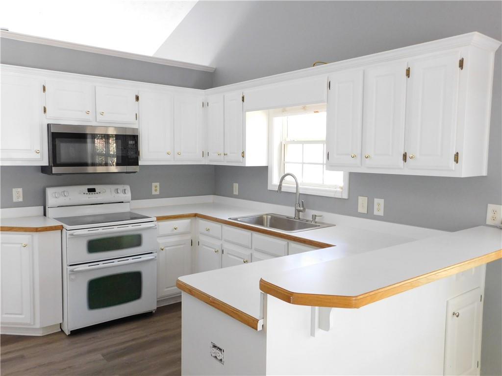 2614 Carolina Court Bethlehem, GA 30620 - Photo 2 of 42 a kitchen with appliances a sink and a stove