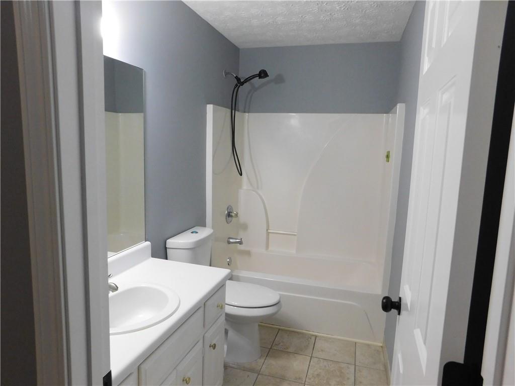 2614 Carolina Court Bethlehem, GA 30620 - Photo 24 of 42 a bathroom with a sink a toilet and shower